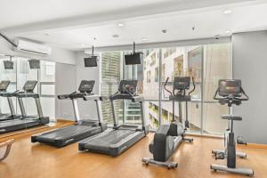 a gym with treadmills and elliptical machines at Sepia By Kozystay - MACAN Museum - Kebon Jeruk in Jakarta