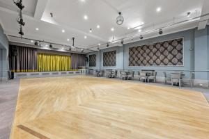 a large ballroom with a wooden floor and chairs at Royal Whitby in Whitby