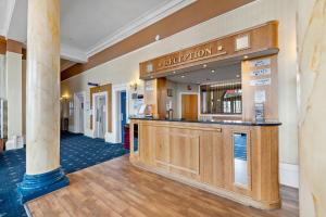 a lobby of a hotel with a reception counter at The Royal Hotel Whitby in Whitby