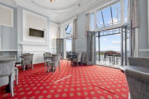 a meeting room with chairs and a red carpet at The Royal Hotel Whitby in Whitby