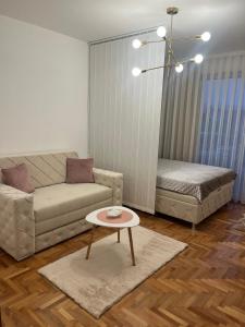 a living room with a couch and a coffee table at Apartman Nini in Kraljevo