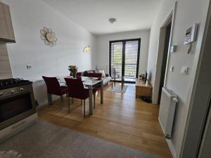 a kitchen and dining room with a table and chairs at Apartman Britt in Zagreb