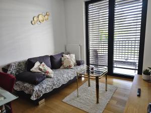 a living room with a couch and a table at Apartman Britt in Zagreb