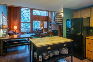 a living room with a table and a kitchen at 98 Elk Horn in Whitefish