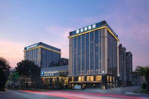 a large building with a sign on the side of it at Wyndham Xishuangbanna Qingquan in Jinghong
