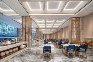 a rendering of a restaurant with tables and chairs at Wyndham Xishuangbanna Qingquan in Jinghong