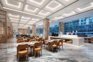 a rendering of a restaurant with tables and chairs at Wyndham Xishuangbanna Qingquan in Jinghong