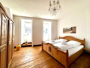 a bedroom with a wooden bed and a chandelier at Ferienwohnungen-Traben-Trarbach in Traben-Trarbach