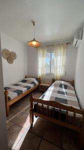 a bedroom with two beds and a window at Beauty 6-pers Villa Alfaz del pi in Cautivador +32 photos