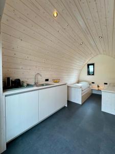 a kitchen with a counter and a sink in a room at Camping Zee van Tijd Holwerd in Holwerd