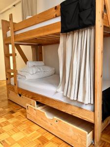 a bunk bed in a room with a bunk bed in a house at Boogalow Hostel in Gijón