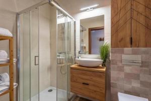 a bathroom with a glass shower and a sink at Apartament B3 Green Resort z Basenem, Sauną, Jacuzzi - 5D Apartments in Szklarska Poręba