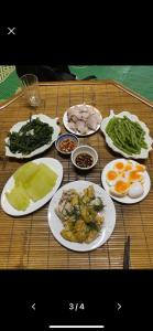 a table with plates of food on top of it at Nhà Cổ Bản Giốc Homestay - Làng đá Khuổi Ky in Bản Piên