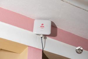 a white electrical outlet on a pink and white wall at Mara Home Away in Lira, Uganda in Lira