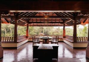 a pavilion with chairs and a table in a room at Panchavati Villa in Manipala
