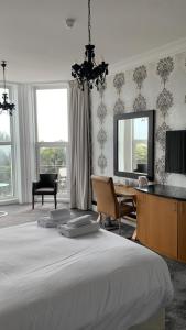a bedroom with a bed and a desk and a mirror at Citrus Hotel Eastbourne by Compass Hospitality in Eastbourne