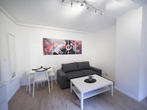 a living room with a couch and a table at Modern Apartment in Schwarzenbek in Schwarzenbek