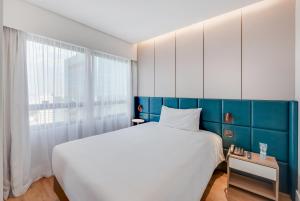 Radisson São Paulo Paulista客房内的一张或多张床位