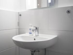 a bathroom sink with a bottle of soap on it at Modern Apartment in Schwarzenbek in Schwarzenbek