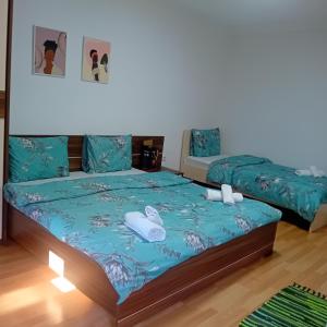 1 Schlafzimmer mit 2 Betten und blauer Bettwäsche in der Unterkunft Gogo Apartments in Ohrid