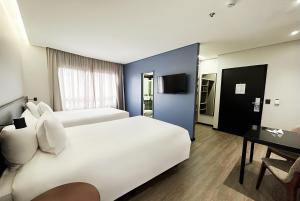 Radisson São Paulo Paulista客房内的一张或多张床位