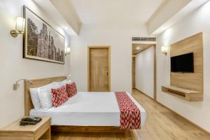 Postel nebo postele na pokoji v ubytování Lemon Tree Premier City Center