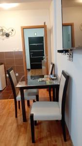 a dining table and chairs in a room at Apartman Andrić in Višegrad