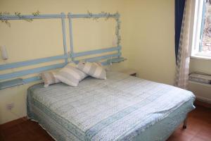 a bedroom with a bed with three pillows on it at Casa sul mare in Procchio