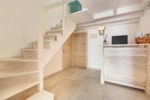 a staircase in a room with wooden shelves at Clara Domus in Gallipoli