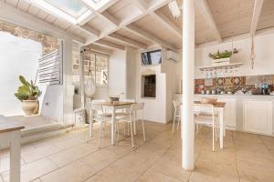 a kitchen and dining room with a table and chairs at Clara Domus in Gallipoli
