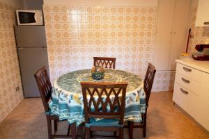a kitchen with a table with four chairs and a refrigerator at Posa in Santa Margherita Ligure