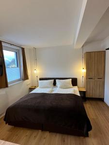 a bedroom with a large bed with two pillows at Willi‘s Studio in Saalbach Hinterglemm