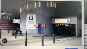 a parking garage with a parking lot with a parking meter at Appartement am Tegeler See in Berlin