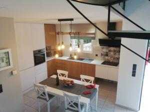 a kitchen with a table and chairs in a room at Jasmin & Olives in Érfoi