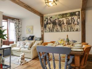 a living room with a table and a couch at The Old Byre in Salisbury