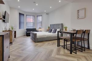 a bedroom with a bed and a table and a desk at Ashley Road Apartment 1 in Poole