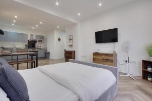 a bedroom with a large bed and a kitchen at Ashley Road Apartment 1 in Poole