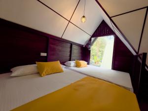 a bedroom with two beds in a tent at Eco Knuckles Holiday Lodge in Kandy