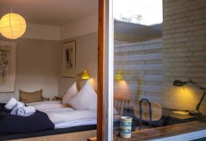 a bedroom with a bed with white pillows at Fuglsang Herregaard Hotel in Nykøbing Falster