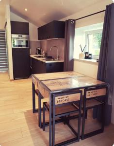 a kitchen with a wooden table and a counter top at L'Essentiel à Francorchamps in Francorchamps