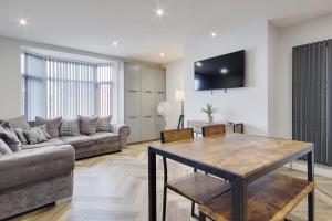 a living room with a couch and a table at Ashley Road Apartment 2 in Poole