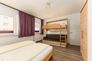 a bedroom with two beds and a bunk bed at Linz CITY in Linz