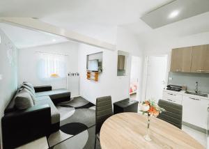 a living room with a table and a kitchen at Apartman Sunny Hills in Krapina