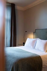 מיטה או מיטות בחדר ב-Hotel Villa Trompenberg