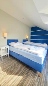 a bedroom with two beds with blue walls at Dom nad Morzem Pleśna78 in Pleśna +28 photos