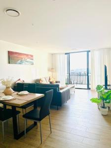 a living room with a couch and a table at The Residences at The Peninsula in Gold Coast