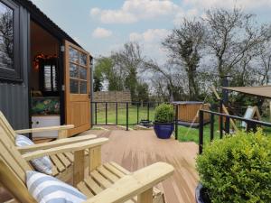 a patio with two chairs and a house at Southdown in Retford