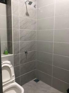 a bathroom with a toilet and a shower stall at D' HOME MERIDIAN in Kluang