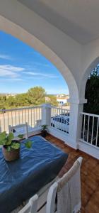a patio with a table and chairs on a balcony at Apartamento 203 Castell Sol CB in Arenal d'en Castell