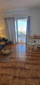 a living room with a table and chairs and a dining room at Apartamento 203 Castell Sol CB in Arenal d'en Castell